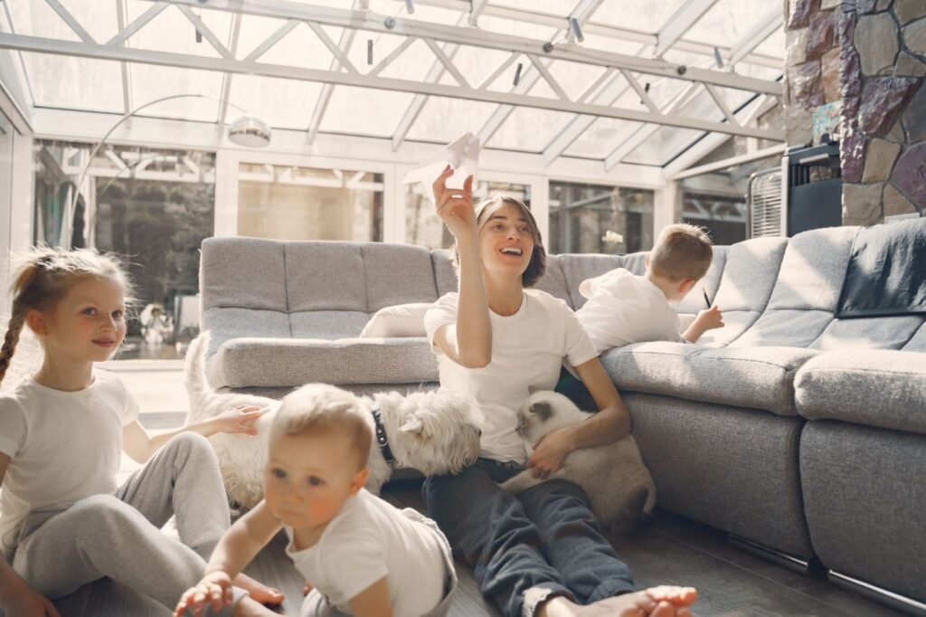 A family and their pets playing together indoors